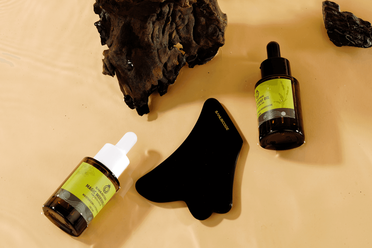 black obsidian gua sha stone and facial gua sha oil kit lay in water, sandalwood stand by, beige background